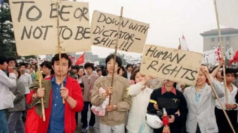 Beijing residents holding placards written in english walk in procession on May 18, 1989 in support to student hunger strikers who entered the 6th day at Tiananmen Square during 